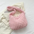 Light pink bubble texture cloud bag with soft ruched design on white blazer backdrop - Pink
