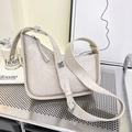 Chic beige crocodile embossed underarm bag with silver buckles on a wide shoulder strap - Off-white