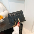 Glossy black quilted crossbody bag with golden chain strap and rectangular lock detail - Black