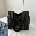 Black quilted puffer tote bag with large capacity and soft padded shoulder straps - Black