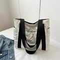 Metallic silver quilted tote bag with black straps and spacious padded design - White