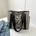 Quilted silver puffer tote bag with black handles and spacious side pockets - Silver
