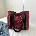 Quilted burgundy nylon tote bag with black strap and padded finish in deep red color - Red