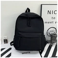 Detail of waterproof black nylon backpack showing woven zipper pulls and front pocket - Black