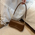 Brown faux leather underarm bag with curved bottom design and gold metal chain hardware - Brown