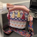 Ethnic bohemian woven bucket bag with colorful tassels and patterned shoulder strap - Pink