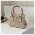 Detailed view of straw mini tote with floral embroidery and vegan leather handles - White