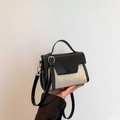Chic black and white woven straw handbag with adjustable leather shoulder strap - Black