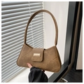 Detail of caramel suede baguette bag featuring a textured finish and golden buckle - Brown