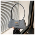 Close-up of grey wool-textured baguette bag with a rectangular gold metal clasp detail - Blue
