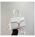 Detail of white faux leather tote with crocodile pattern embossing and gold metal lock - White