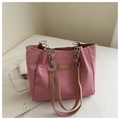 Detailed close-up of pink fabric tote bag with leather tag and chain strap handles - Pink