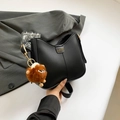 Minimalist black crescent leather shoulder bag with fashion label and plush charm - Black With Pendant