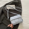 Light blue woven leather crossbody bag with minimalist square design and silver buckle - Blue