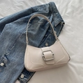 Chic cream leather baguette bag with a striking silver square metal buckle and shoulder strap - White