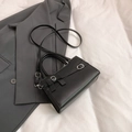 Elegant black square handbag with bow accent and silver clasp in a matte leather finish - Black