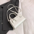 Chic creamy white crossbody bag with bow detail and silver buckles in life scene - White
