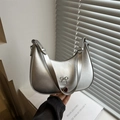 Silver metallic hobo bag with bow detail and sleek crescent shape for modern styling - Silver