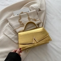 Golden crocodile embossed handbag with V-shaped metal buckle and gold chain strap - Gold