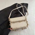 Chic cream straw crossbody bag with V-weave pattern and seashell charm for summer vacation - White