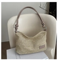 Detail of woven straw bag with a knotted brown leather handle and metal rings - Khaki