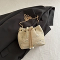 Beige woven drawstring bucket bag featuring floral embroidery and gold chain strap - Khaki