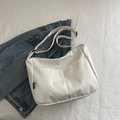 Minimalist white nylon crossbody bag with dual front pockets and adjustable strap - White