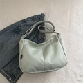 Minimalist mint green canvas crossbody bag featuring front pockets and vertical stitching - Green