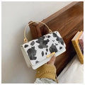 Women's chic cow print bag with golden circular metal handle and chain strap detail - White