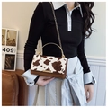 Fashionable cow print crossbody bag with brown leather accents and gold chain strap - Brown