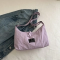 Light purple Fanyissa nylon crossbody bag with adjustable strap on denim backdrop - Purple