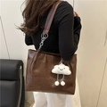Retro dark brown tote bag with chain strap and plush charm worn by a model - Coffee with Pendant