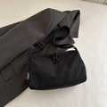 Minimalist black large capacity nylon crossbody bag with adjustable strap and textured finish - Black