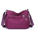 Large purple nylon crossbody bag with heart quilting and multiple zip pockets - Fuschia