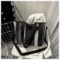 Detailed view of textured striped tote bag with brown straps on a white blazer - Black