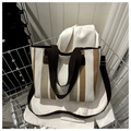 Detailed view of striped canvas tote bag inside a metallic trolley with leather straps - Khaki