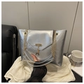 Detail of silver metallic tote bag with golden deer charm and chain shoulder strap - Silver
