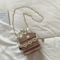 Detail of straw bucket bag featuring large pearl accent and white resin chain - Khaki
