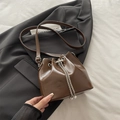 Brown glossy bucket bag featuring water ripple texture and pearl chain drawstring details - Brown