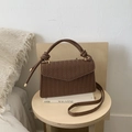 Detail of brown woven texture small square bag with braided handle and long shoulder strap - Brown