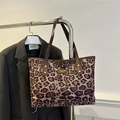 Leopard print canvas tote bag with brown leather straps and gold emblem detail - Pink