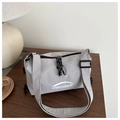 Close-up of light grey water-resistant nylon crossbody bag with white FANYISSA logo - Gray