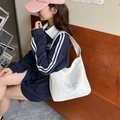 Minimalist white canvas tote bag with blue typography and wide shoulder strap - White