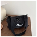 Detail of black nylon dumpling bag featuring dual zippers and FANYISSA brand logo - Black
