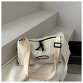 Detail of off-white nylon dumpling bag with black FANYISSA logo and woven texture - White