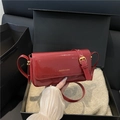 Glossy red patent leather baguette bag with adjustable strap in a black gift box - Red