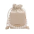 Chic cream-white woven bucket bag with elegant pearl top handle and gold metal chain strap - Beige