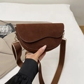Brown matte saddle bag with stylish wide shoulder strap and elegant wave edge detail - Brown