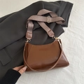 Dark brown underarm baguette bag with glossy finish and patterned wide strap - Tan