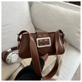 Detail of vintage brown shoulder bag with polished silver buckle and metal eyelet strap - Tan